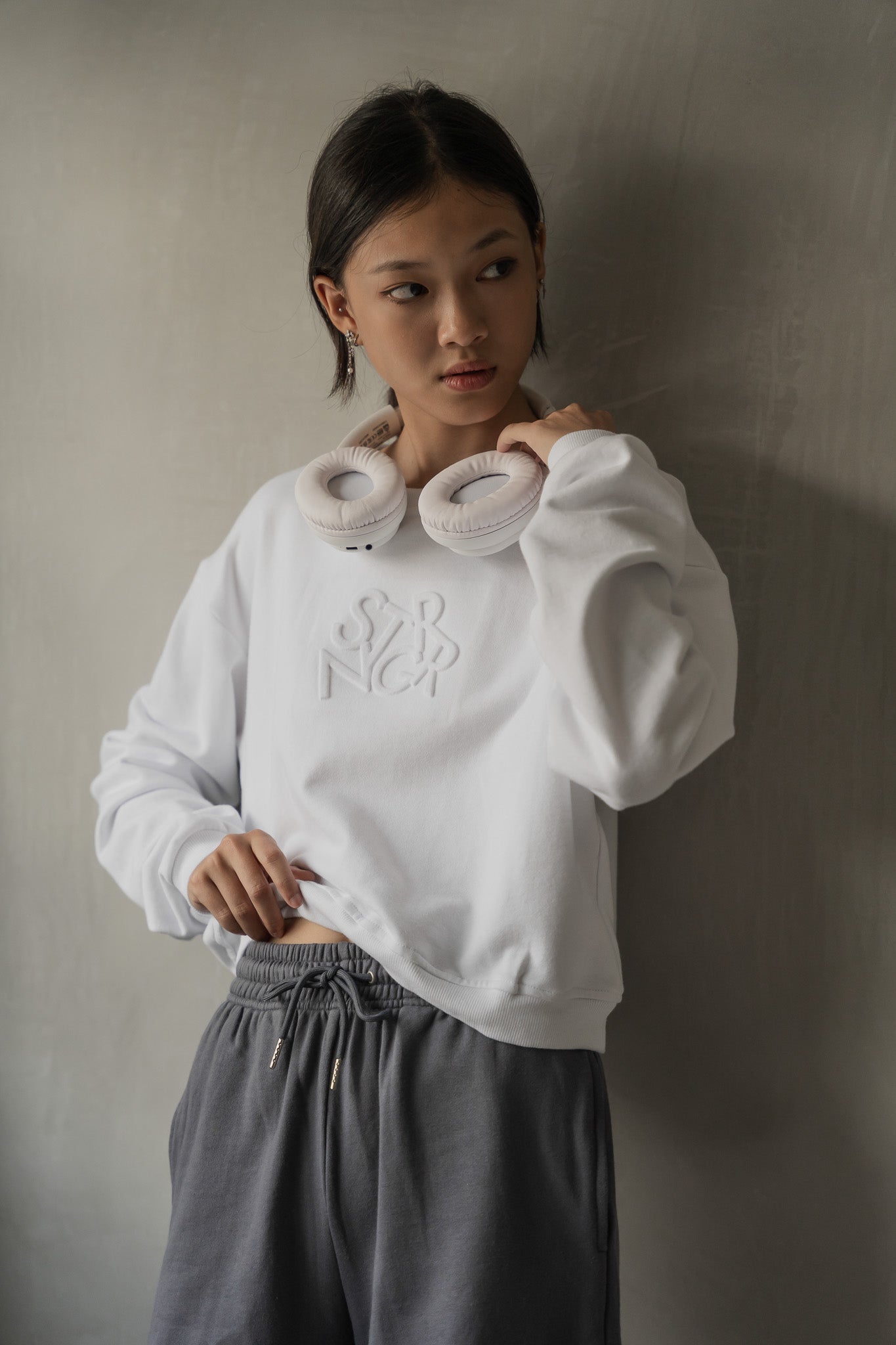 STRANGER Embossed Logo Cropped Sweatshirt in White